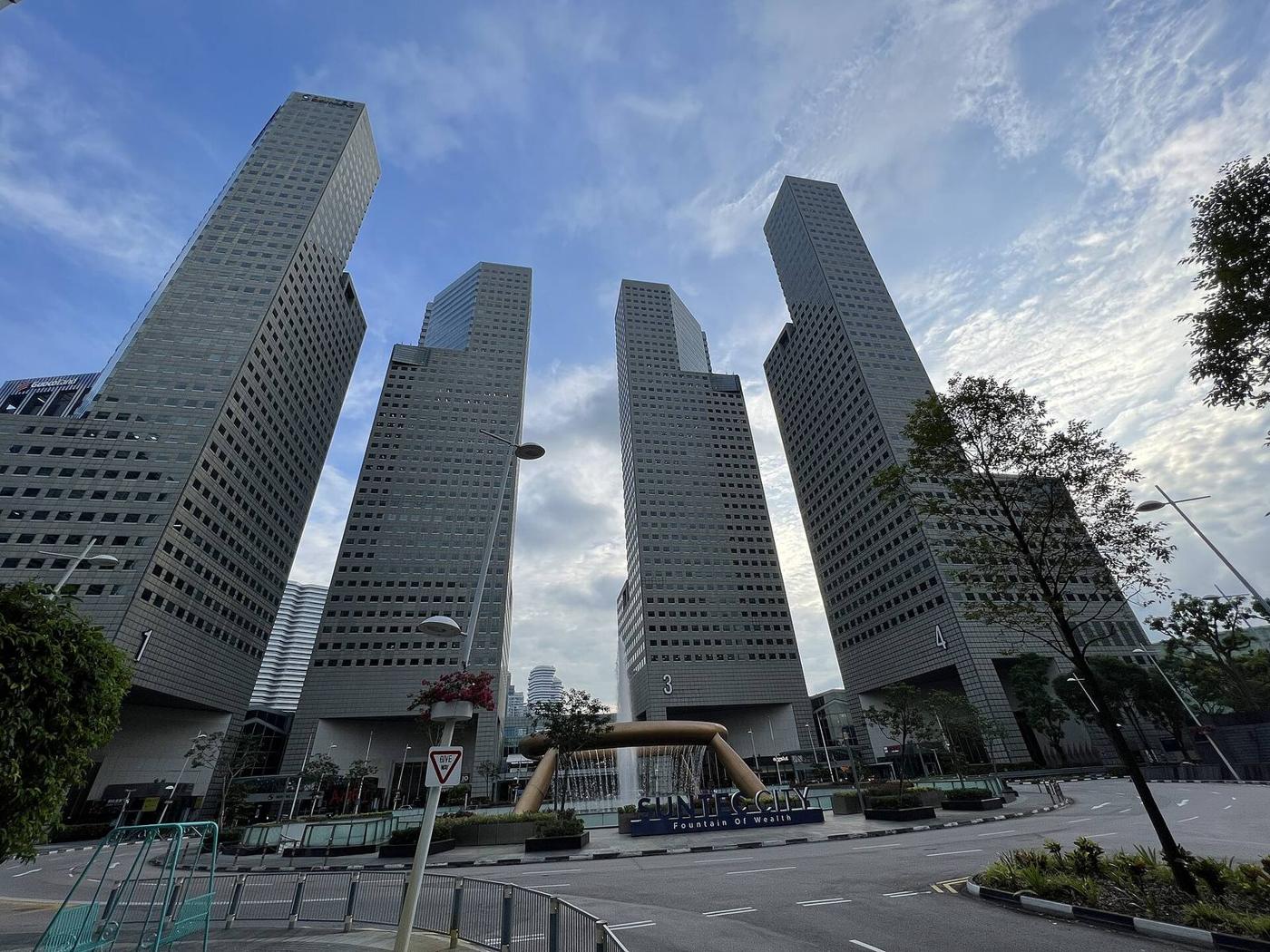The towers of Suntec City, Singapore, seen from street level.